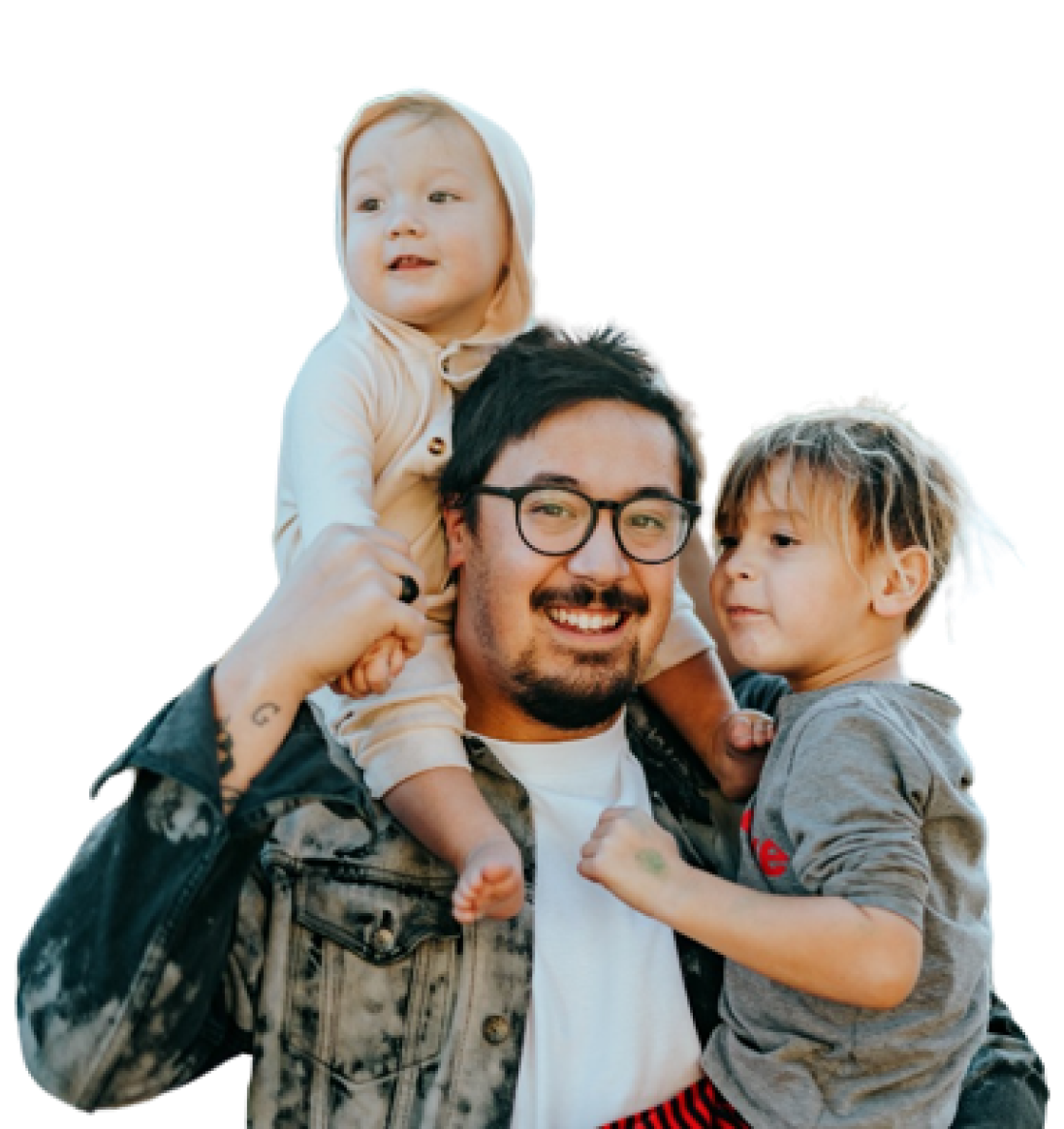 A happy man carrying young boy in one arm and holding a toddler safely around his shoulders with his other arm